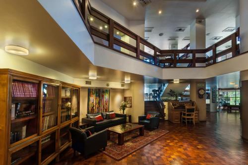 a large living room with couches and a table at Hotel de la Cañada in Córdoba