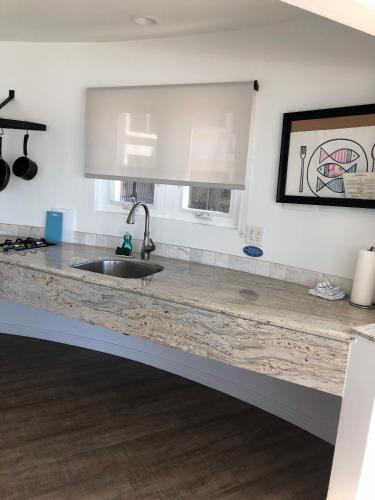 a kitchen with a sink and a counter top at Sea Horse Resort in San Clemente