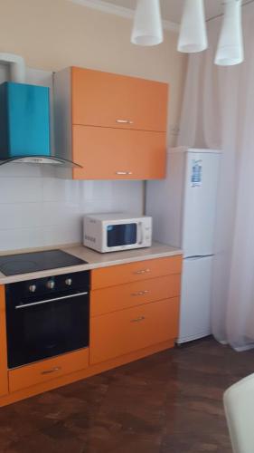 a kitchen with a stove and a microwave at Альтаир1 in Odesa
