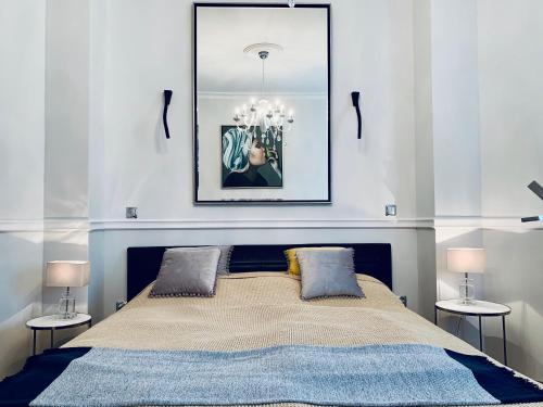 a bedroom with a large bed with two side tables at Villa Bagatelle - Luxury apartment in Nice