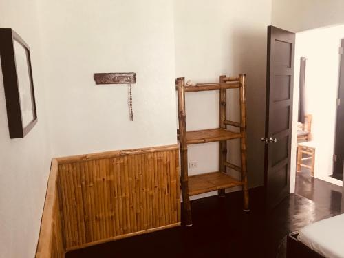 a room with a wooden shelf next to a door at Everyday Sunday Hotel & Cafe in Bantayan Island