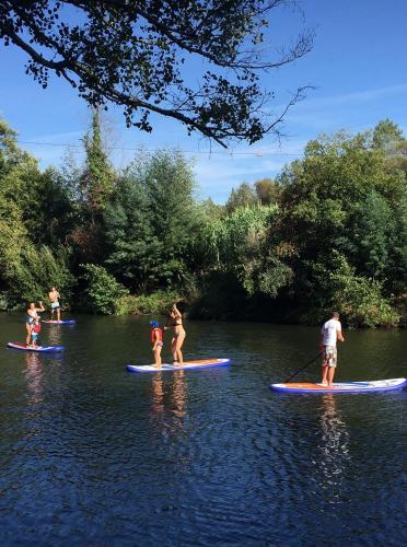 a group of people on paddle boards in the water at Adore Portugal Bungalow Natureza & Vista de Serra in Lousã