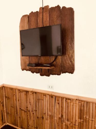 a flat screen tv hanging on a wall at Everyday Sunday Hotel & Cafe in Bantayan Island