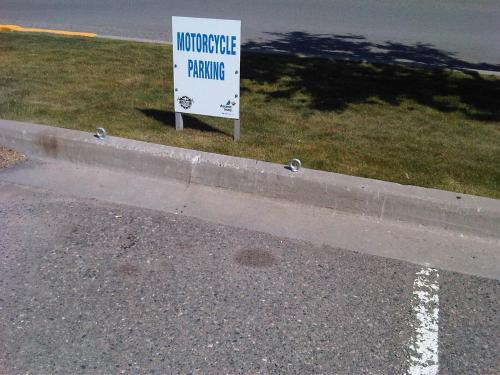 a sign on the side of a road with a parking sign at Accent Inns Kamloops in Kamloops