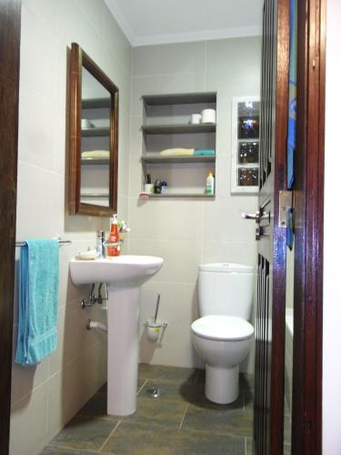 a bathroom with a white toilet and a sink at View Camelias House by SixtyFive Boutique Home in Ericeira