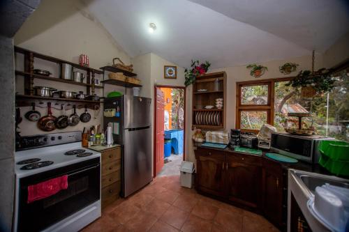 a kitchen with a stove and a refrigerator at Santa María del Lago in San Pedro La Laguna