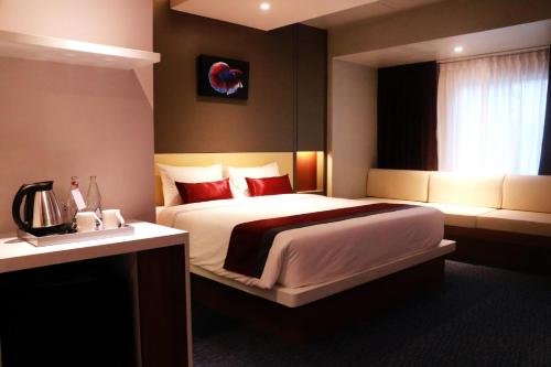 a bedroom with a large bed and a window at Star Hotel Chiang Mai - SHA Extra Pus in Chiang Mai