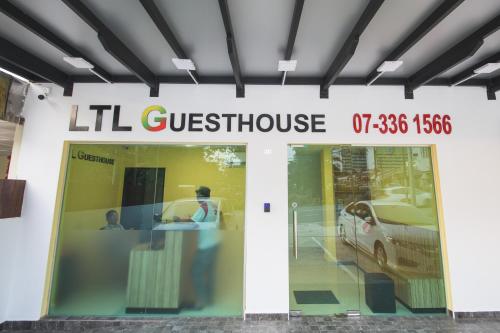a store front with a sign that reads lilian questionnaire at LTL Guesthouse in Johor Bahru