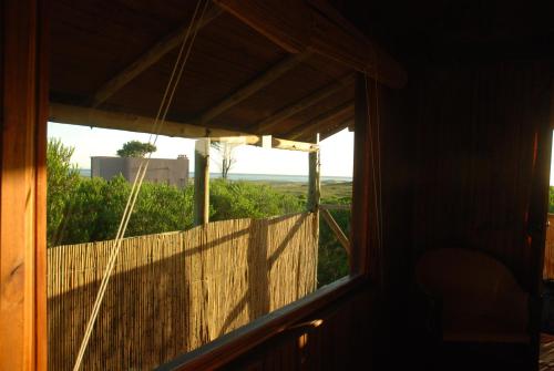 a window of a house with a view of the ocean at Hotel El Refugio nudista naturista opcional in Chihuahua