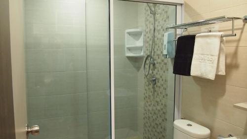 a bathroom with a glass shower with a toilet at Nite & Day Laguna Bintan in Tanjung Pinang 