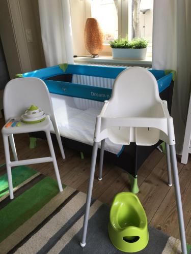 a bedroom with a bed and two chairs and a table at JETHON Studio-Appartement im Grünen in Bernburg