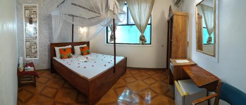 a bedroom with a bed and a window at Mocco Beach Villa in Kendwa