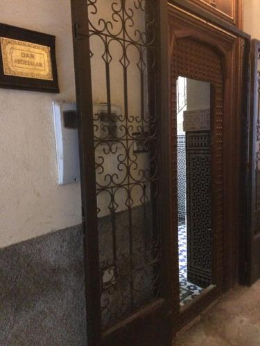 a wooden door with a mirror in a room at Dar Abdesalam in Fès