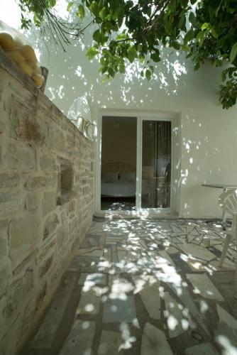 a room with a stone wall and a table at Antonios 1 in Matala