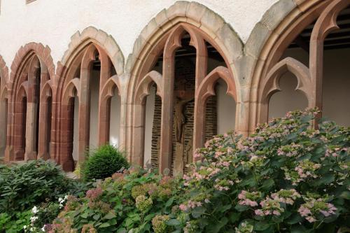 a building with a bunch of arches and flowers at Hotel Belle Vue in Vianden