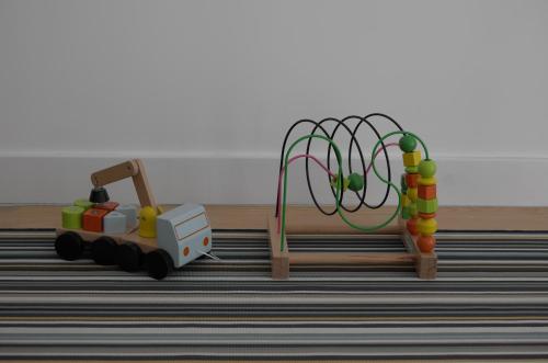 a toy train next to a playground with toys at Double Suite by the Ocean in Paço de Arcos