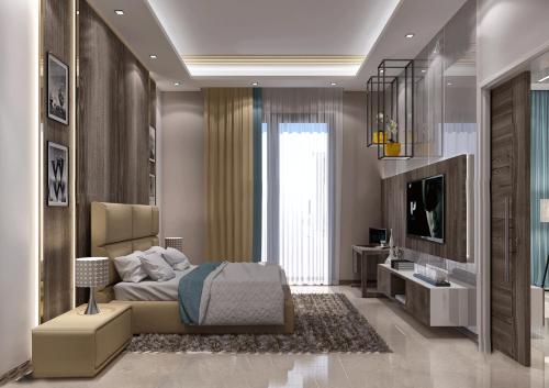 a bedroom with a bed and a television in it at Belad Bont Resort in Salalah