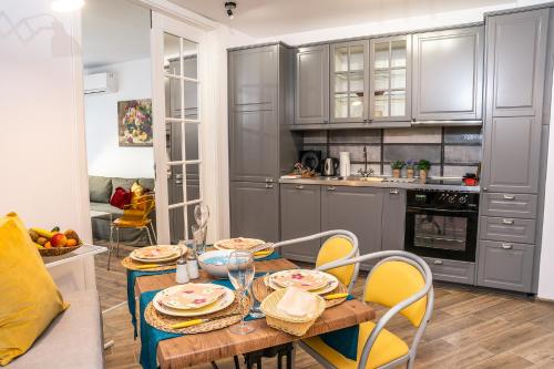 a kitchen with a table and chairs in a kitchen at LOFT in Varna City