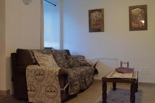 a living room with a couch and a coffee table at Maison d'Antan in Introd
