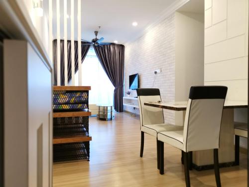 a dining room with a table and two chairs at ExcluSuites Malacca @ The Wave Residence in Melaka