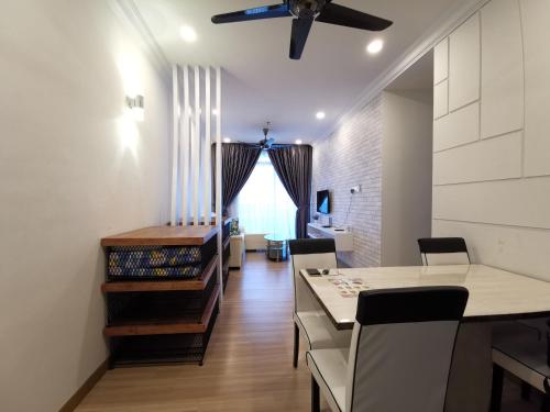 a dining room with a table and a ceiling fan at ExcluSuites Malacca @ The Wave Residence in Melaka