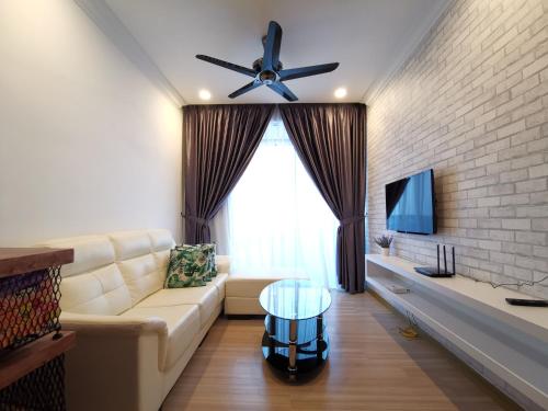 a living room with a couch and a ceiling fan at ExcluSuites Malacca @ The Wave Residence in Melaka