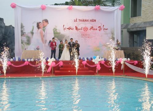 a wedding ceremony in front of a pool at Camela Hotel & Resort in Hai Phong