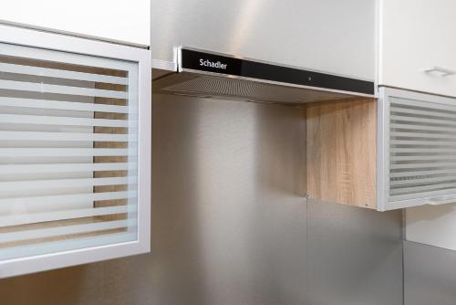 a kitchen with a cupboard and a microwave at Apartment Ariella in Jūrmala