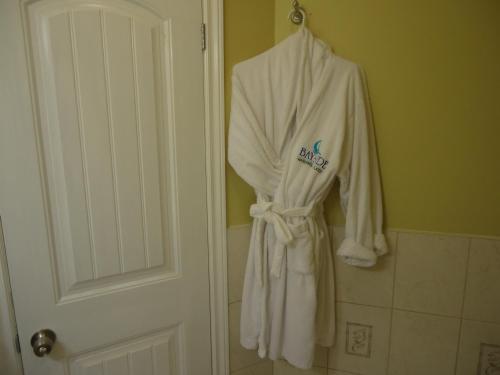 a robe hanging on a door in a bathroom at Bayside Inn & Waterfront Suites in Kingston