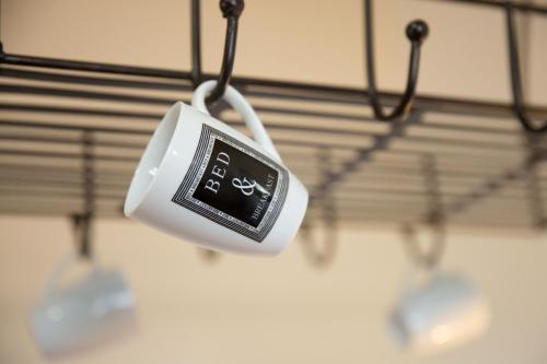 a clock hanging from a hook in a room at Beej Potters in Weert