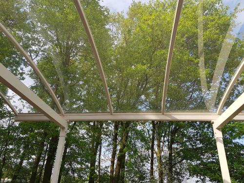 a glass ceiling in a building with trees in the background at Beej Potters in Weert