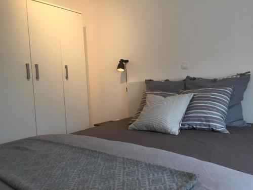 a bedroom with a bed with two pillows and a closet at House Olivia in Pučišća