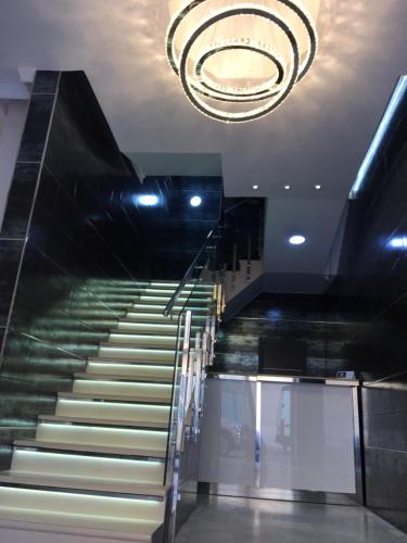 a staircase in a building with a chandelier at Hotel Nacional Melilla in Melilla
