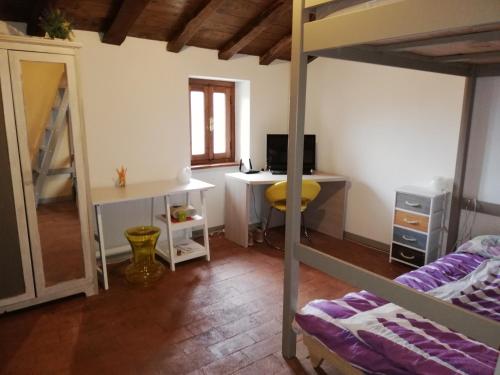 a bedroom with a bed and a desk and a bunk bed at Casa Martino in Villa