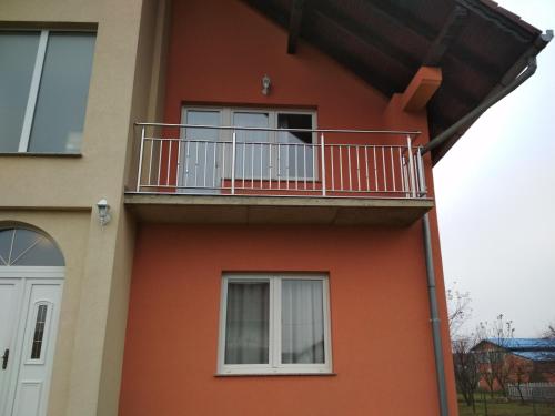 a building with a balcony on the side of it at Apartman Stars in Slavonski Brod