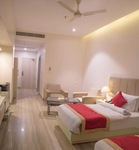 a bedroom with a bed and a living room at The Opal in Rāmpur