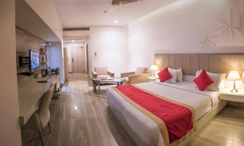 a hotel room with a bed and a desk at The Opal in Rāmpur