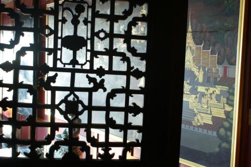 a window with a view of a painting on a wall at Prince Edouard Apartments & Resort Patong Beach Phuket in Patong Beach