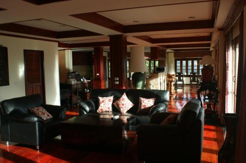 a living room with leather couches and a coffee table at Prince Edouard Apartments & Resort Patong Beach Phuket in Patong Beach