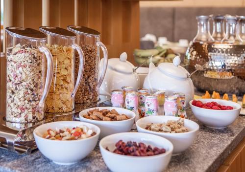 a counter with bowls of nuts and jars of food at Garni Lanzinger in Selva di Val Gardena