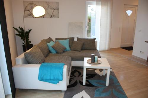 a living room with a couch and a table at Melios in Balingen
