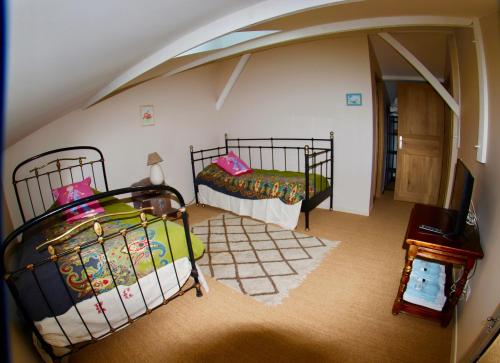 a bedroom with two beds in a attic at Château Trillon in Sauternes