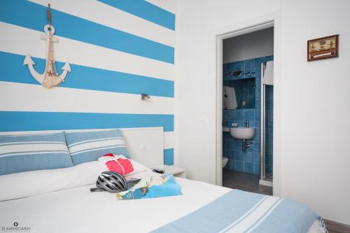 a bedroom with a blue and white striped wall at L'Approdo Dell'Ammiraglio in La Spezia