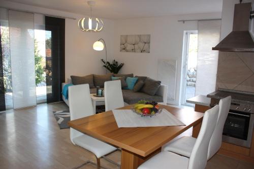 a kitchen and living room with a wooden table and chairs at Melios in Balingen