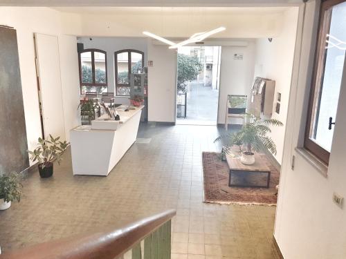 a room with a lobby with a counter and plants at Residence Argentina R.T.A. in Spotorno