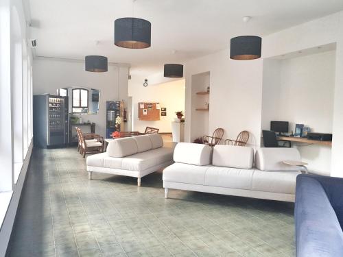 a living room with two white couches and a table at Residence Argentina R.T.A. in Spotorno