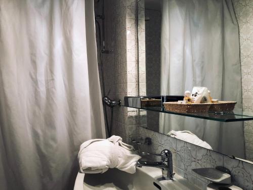 a bathroom with a sink and a mirror at Hotel Regina Terme in Leukerbad