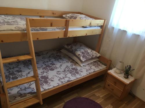 a bedroom with two bunk beds and a table at Croatian Home Apartments in Zadar