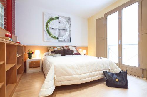 a bedroom with a bed and a large window at Calle Sant Miquel 18, 2º 1ª in Tossa de Mar