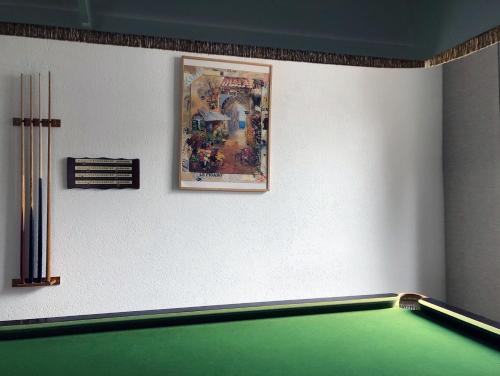 a room with a pool table and a picture on the wall at Hotel Regina Terme in Leukerbad
